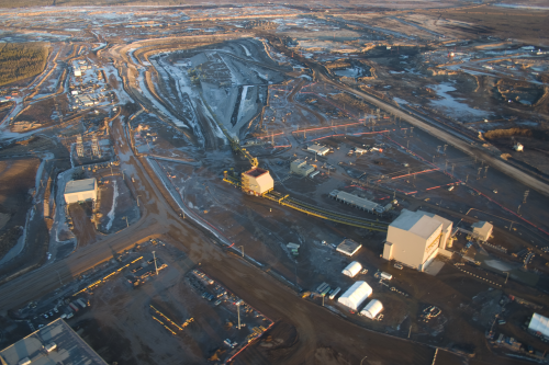 Open-cast mining of tar sands is often used for deposits at or close to the surface, followed by hot water  processing and flotation to release the oil.