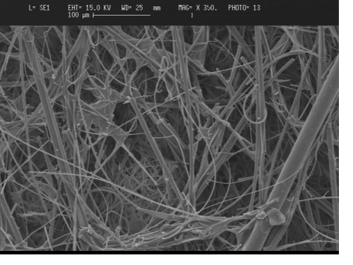 Scanning-electron microscope image of typical air-laid filter medium, showing wide range of fibre diameters, random structure and binder bridges.