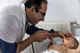 Doctor treating a newborn at the Kabul hospital.