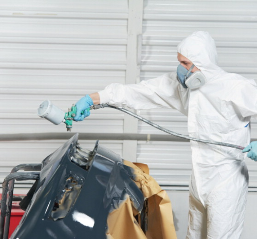 Spraying automotive parts in a paint shop.