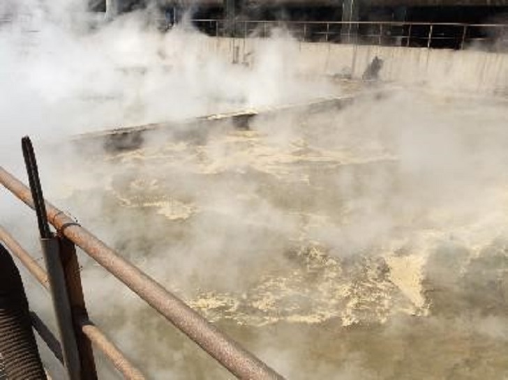 A sink basin with cooling water that is contaminated with iron fragments, sand and mineral particles.