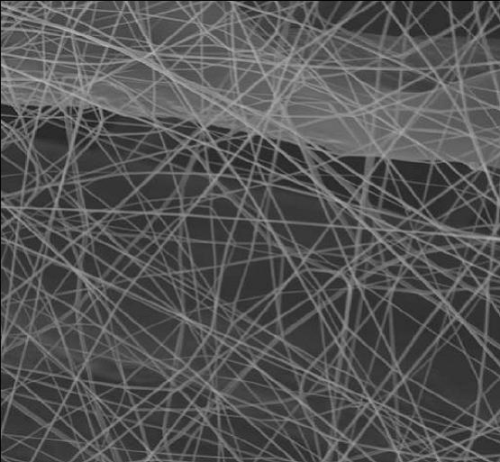 Scanning Electron Micrograph (SEM) of electrospun nanofibers deposited on a cellulose filtration substrate produced using a commercial Nanospider line.