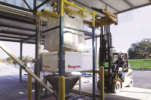 Forklift positions the bulk bag and bag lifting frame onto the cradle atop the discharger frame.