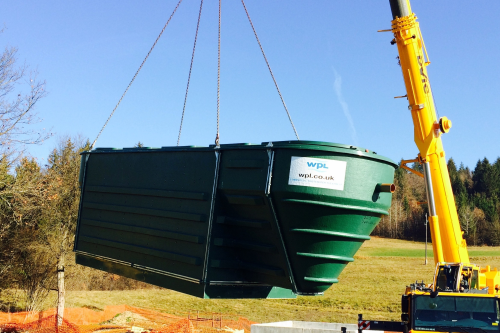 A lorry-mounted crane lowers the first HiPAF packaged treatment unit on site in Zdenska Vas, Slovenia.