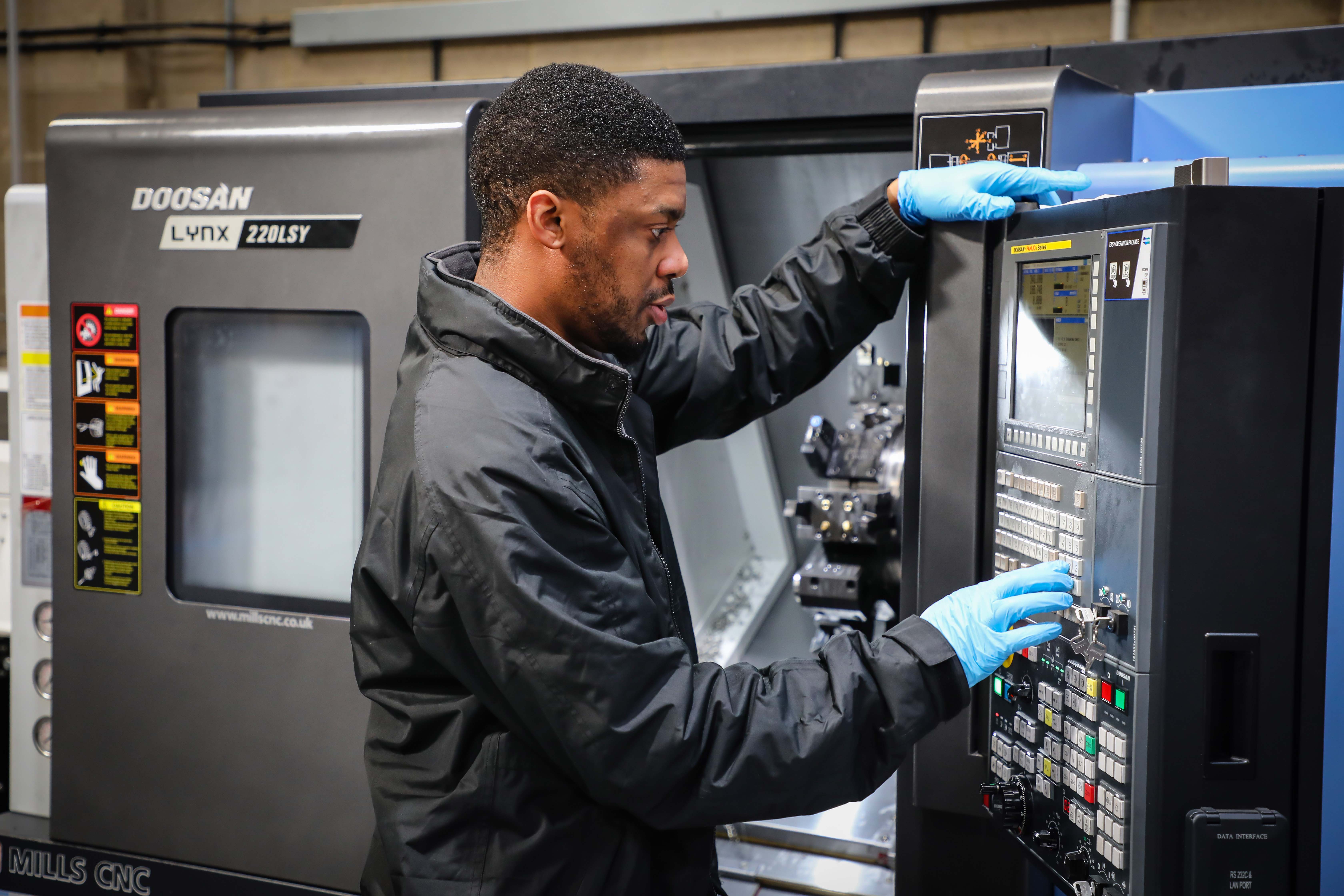 Programming a CNC machining cell in the new metalworking shop at Amazon Filters’ Camberley plant.