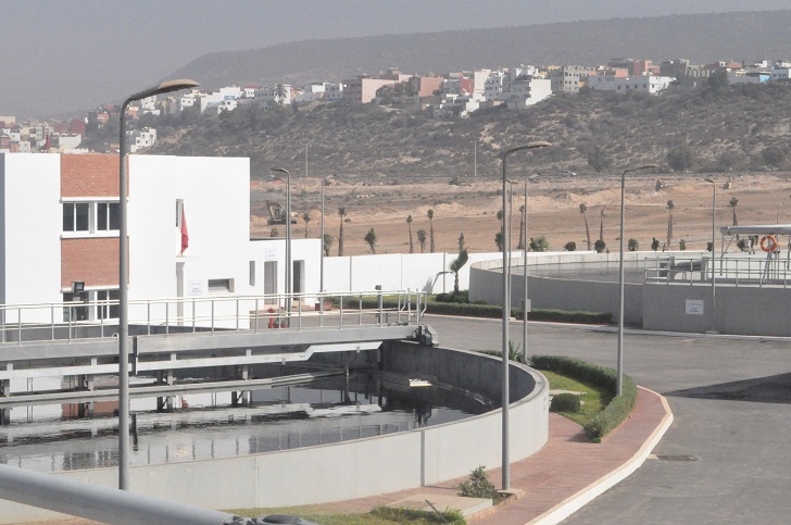 A view of the new plant featuring a clarification tank and the administration building.