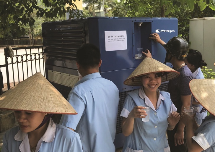 Workers in Vietnam enjoy fresh drinking water from the Watergen unit.