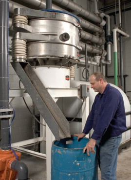 A recycle screening deck (two screens of the same mesh operating in series), retrofitted on top of the screener, increases capacity instead of replacing with a larger diameter unit.