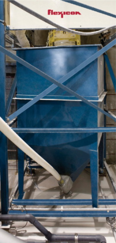 One of two 1.8m3 capacity hoppers holds the contents of a 408 kg bulk bag allowing diatomaceous earth to transfer, unattended, through the flexible screw conveyor to the tank. Load cells under the unloader frame transmit weight loss information to a PLC to achieve accurate batch weight transfer.