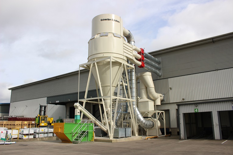 Cyclofilter dust extraction system for composite door manufacture. This return air system delivers filtered air back to the workspace to reduce heating costs.