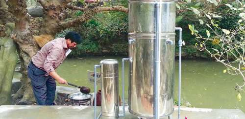 A man tests water that has been through the arsenic-removal system.